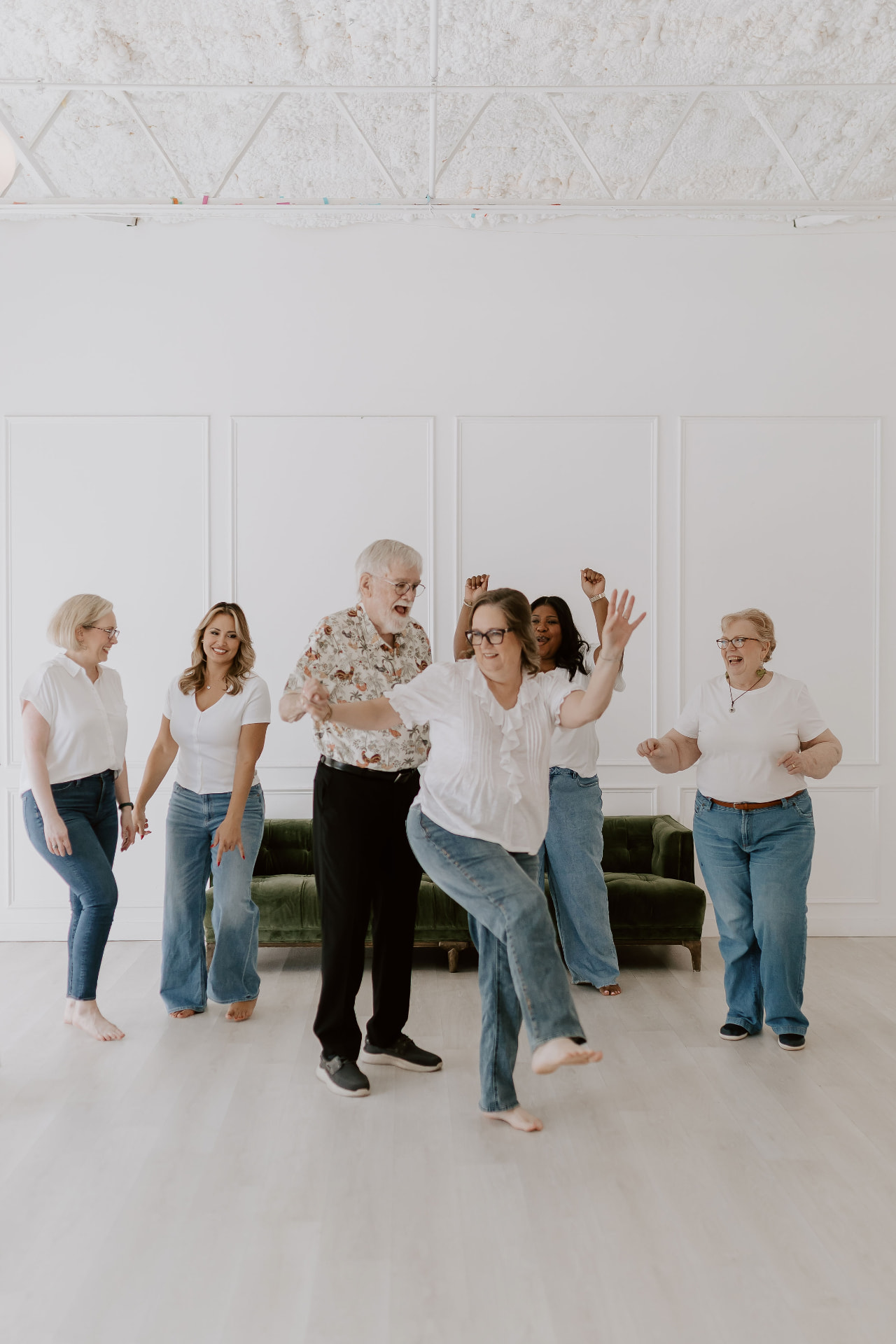 The team dancing together in the studio